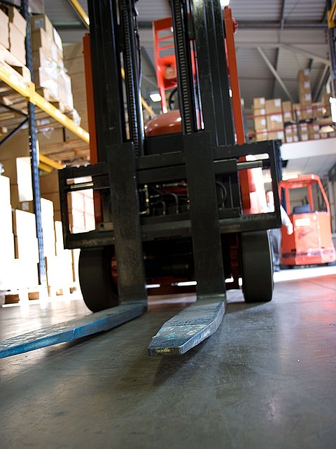 A forklift in a warehouse aisle.