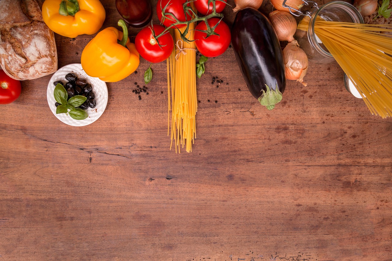 Pasta and vegetables on a wooden table.