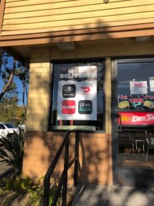 Del Taco's delivery partnerships window sticker.